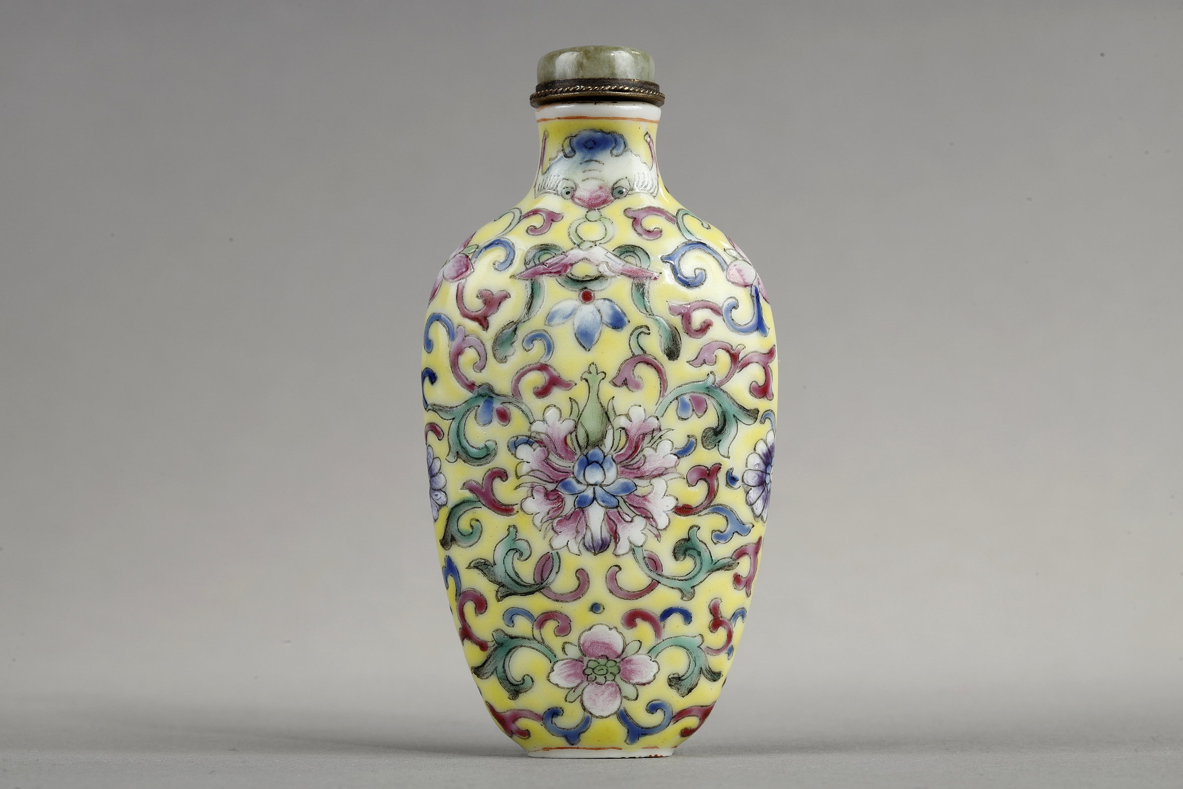 Snuff bottle porcelain has a polychrome decor of stylized flowers and foliage.
China 1890/1930